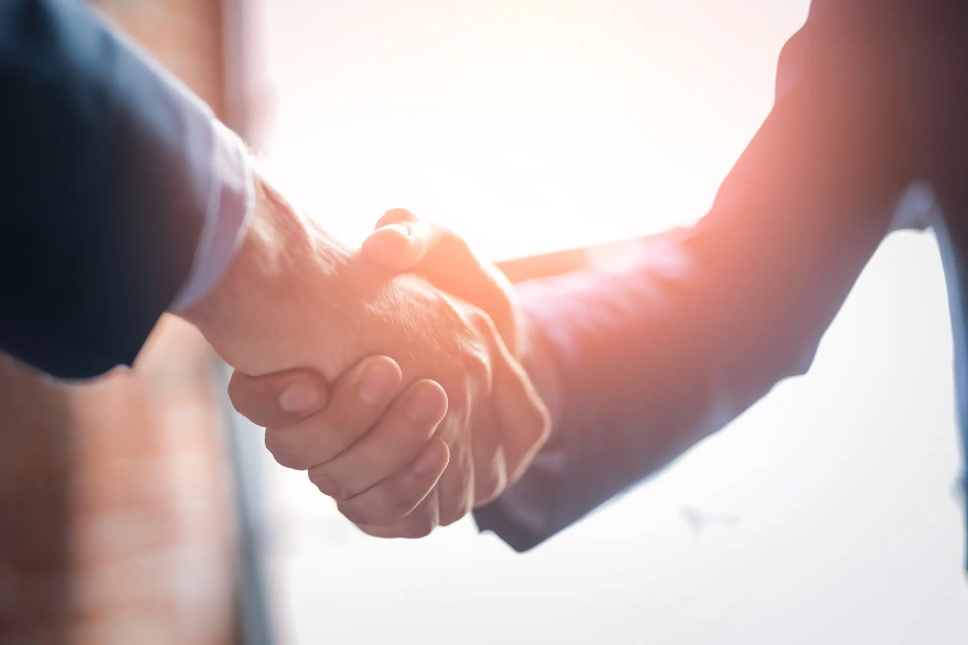 Tenant Retention Strategies | People shaking hands in a meeting
